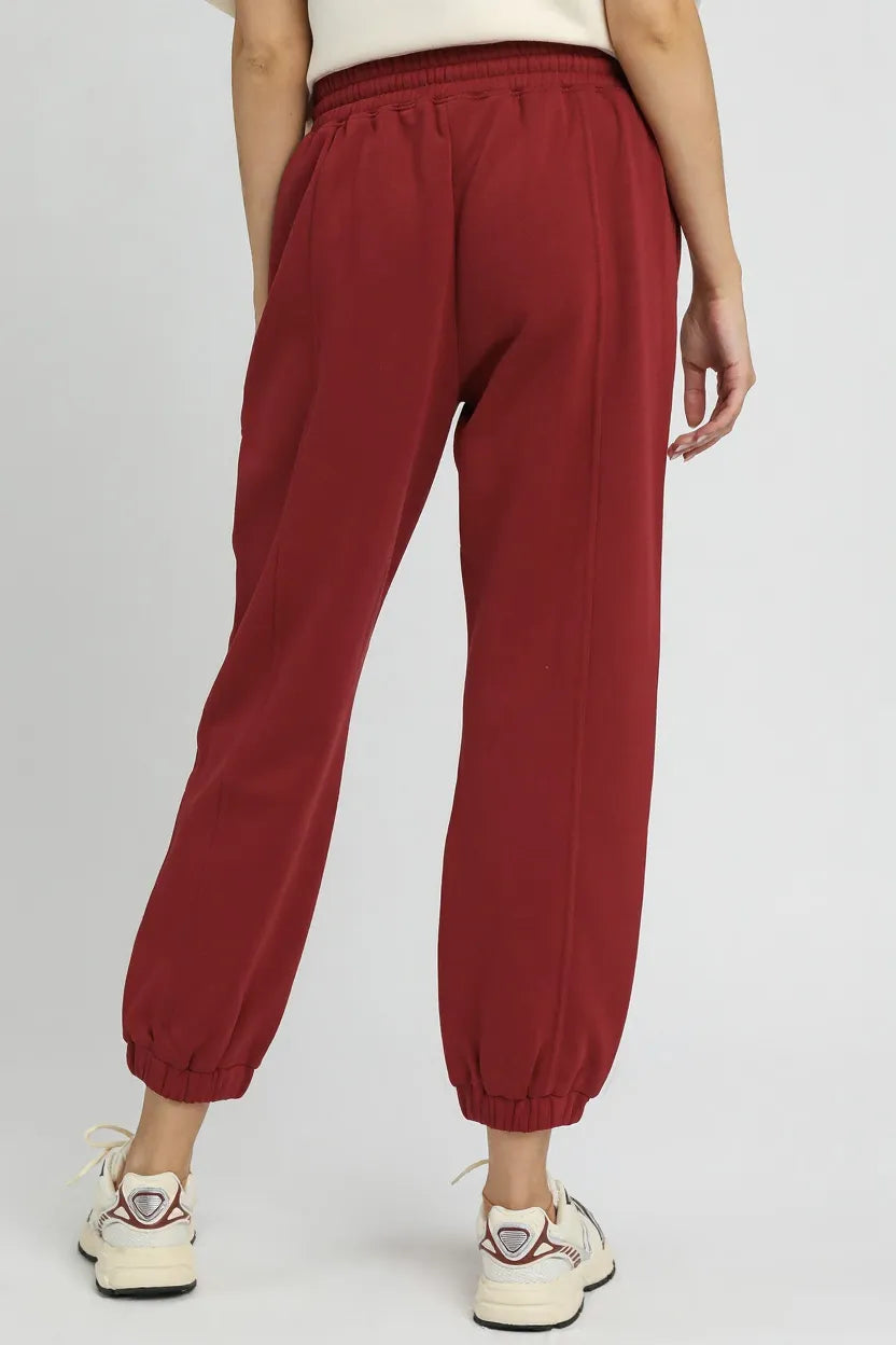 Burgundy Umgee fleece jogger pants with drawstring waist, casual fit, and cozy fleece material.