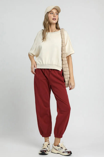 Burgundy Umgee fleece jogger pants with drawstring waist, casual style, soft fabric, and relaxed fit, shown on a model.