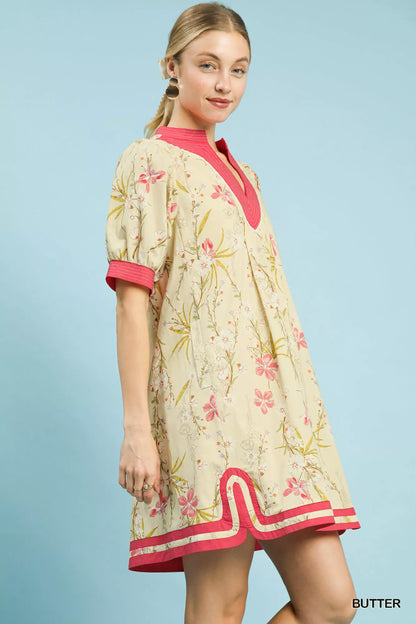 Umgee floral puff sleeve dress with contrast trim, featuring a feminine silhouette and vibrant floral pattern.