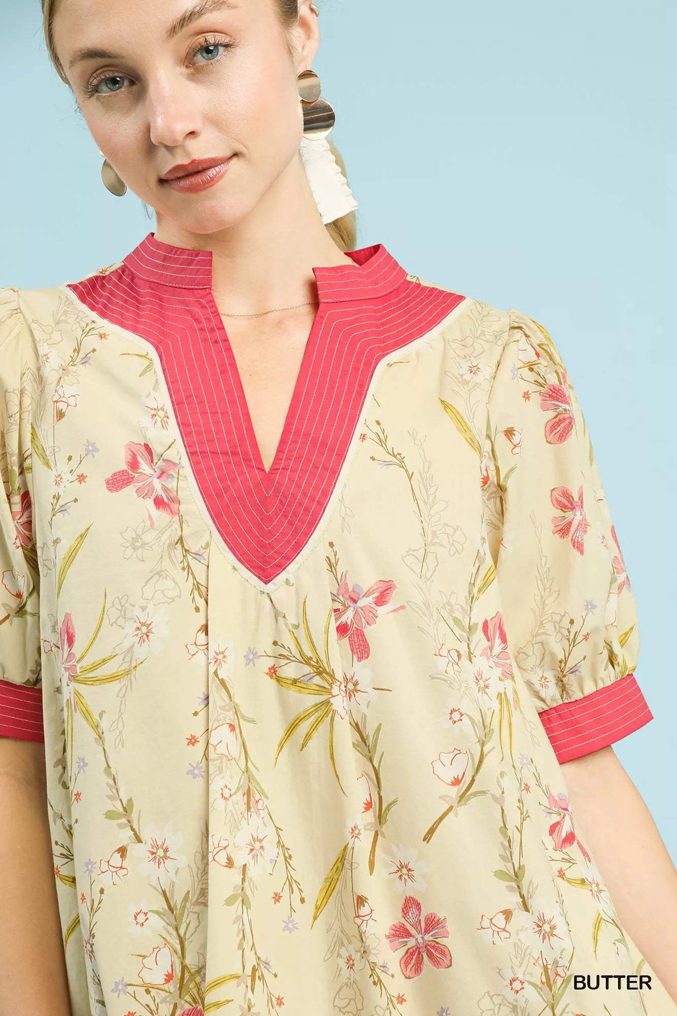 Umgee floral puff sleeve dress with contrast trim, featuring a feminine fit and vibrant floral pattern, perfect for spring or summer wear.