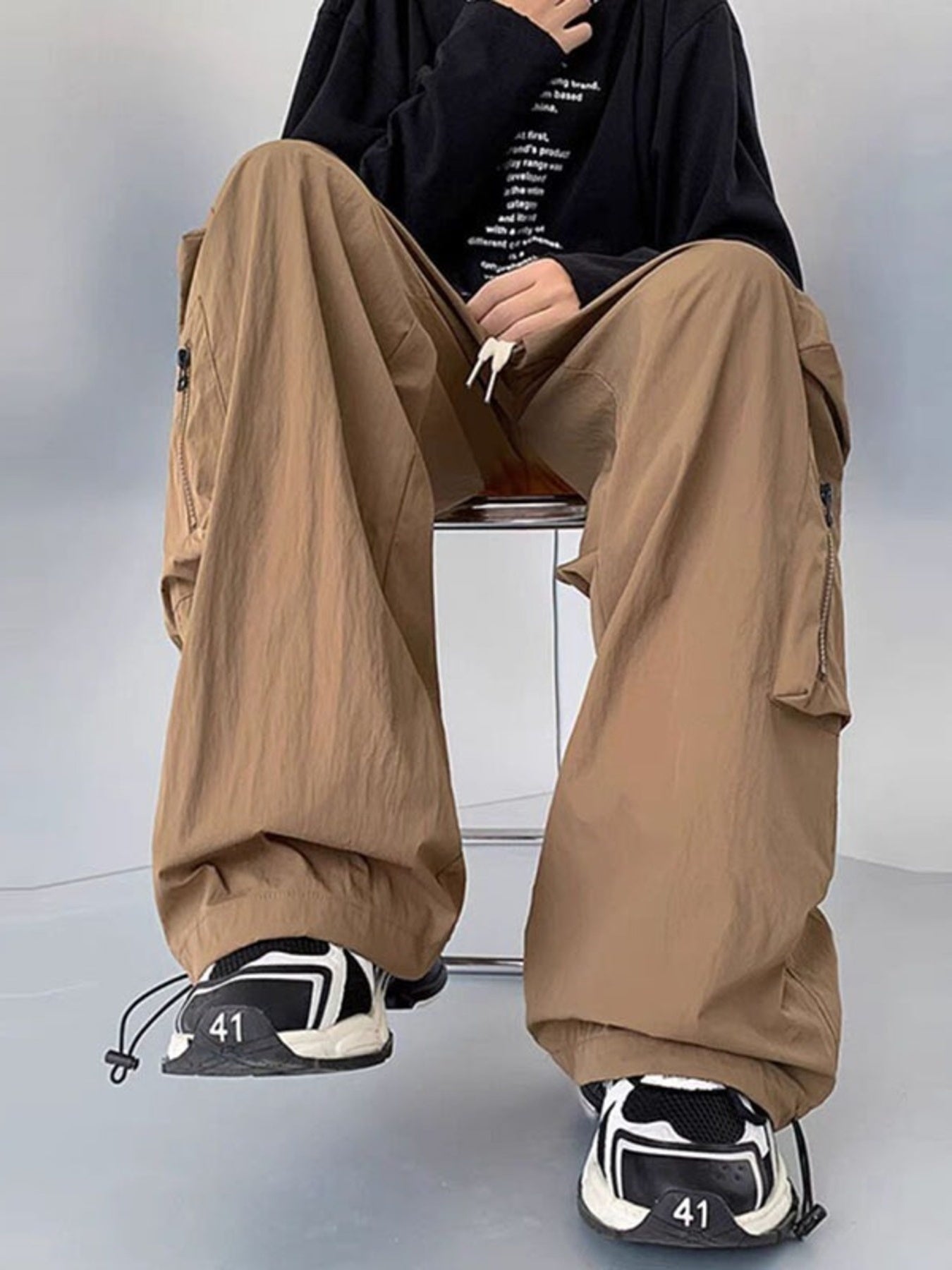 Men's plus size loose fit cargo pants with drawstring in camel color, from Trendsi, shown on a model.
