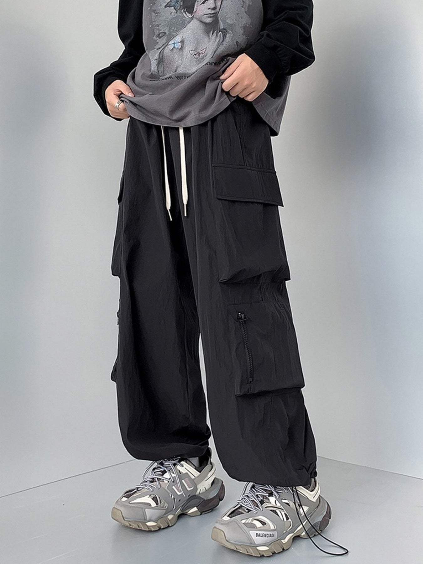 Men's plus size loose fit cargo pants by Trendsi in camel color with drawstring waist and multiple pockets.