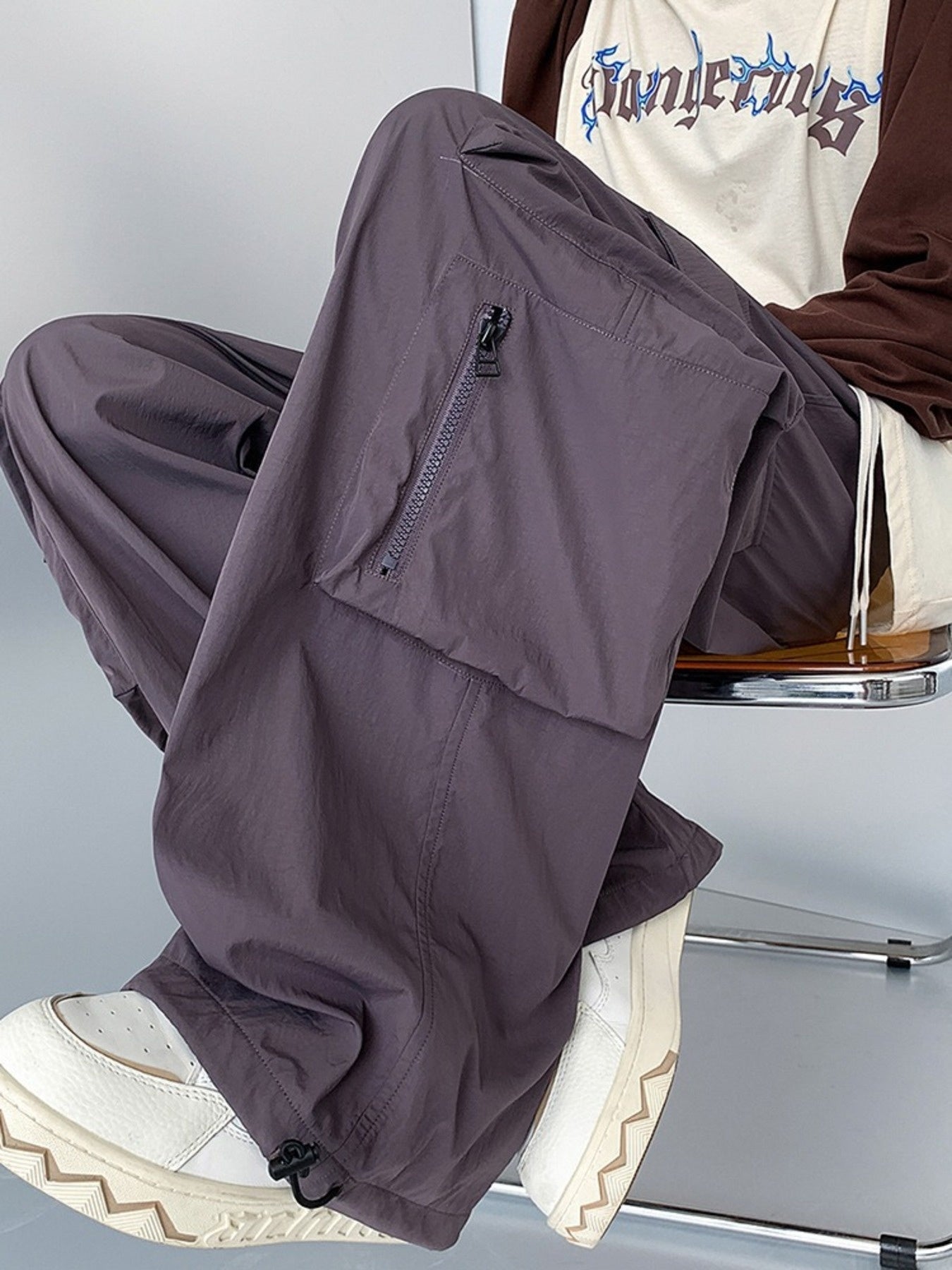 Men's plus size loose fit cargo pants with drawstring in camel color, styled with multiple pockets and relaxed fit.
