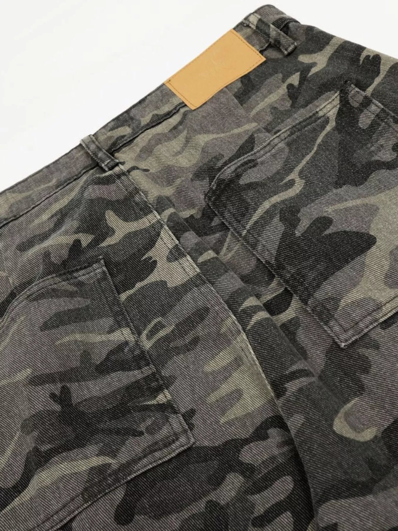 Men's camouflage cargo pants by Trendsi, featuring a green and brown camo pattern, multiple side pockets, and a relaxed fit.