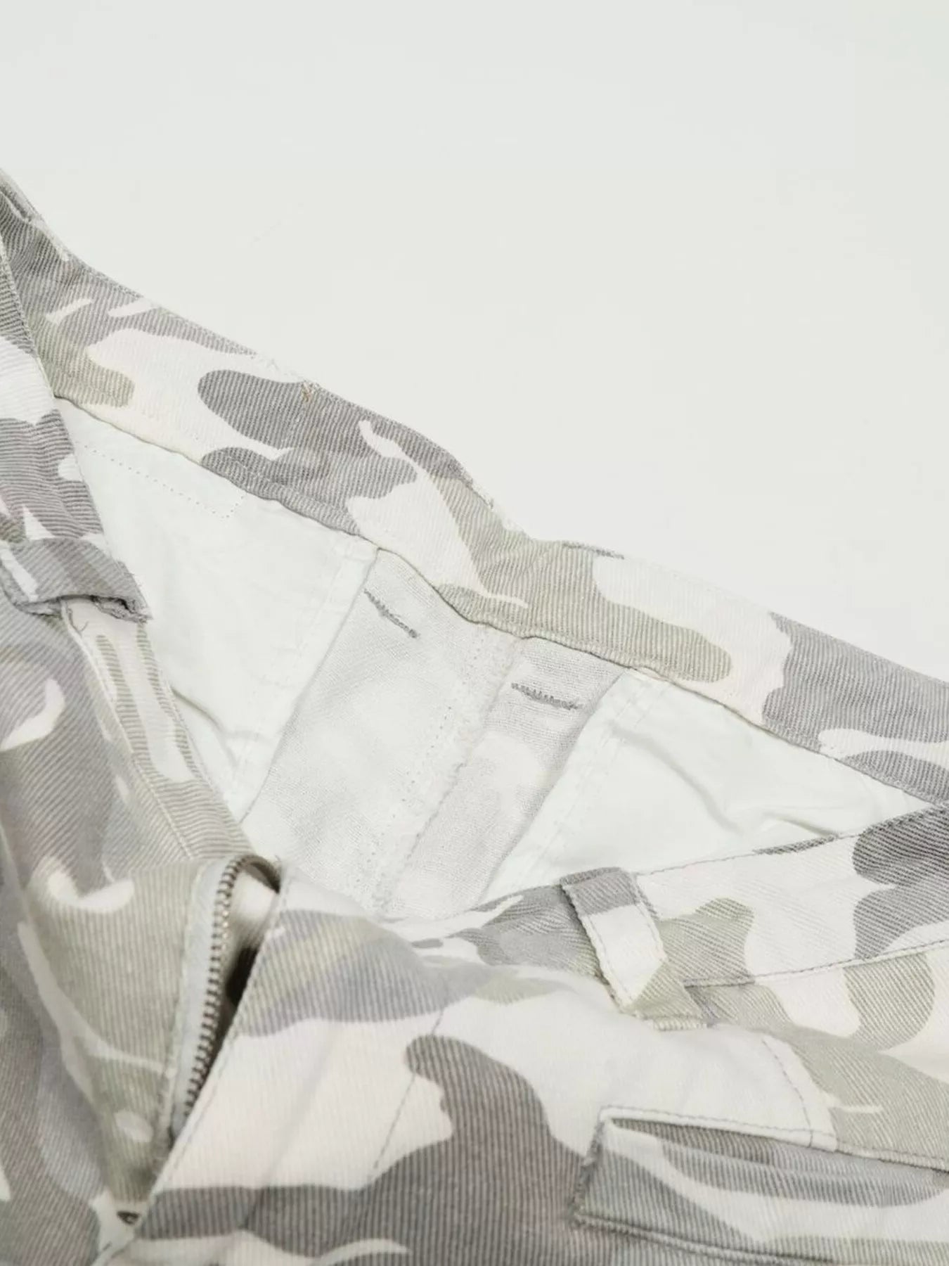 Men's camouflage wide-leg cargo pants by Trendsi featuring a relaxed fit and multiple pockets in a stylish camouflage pattern.