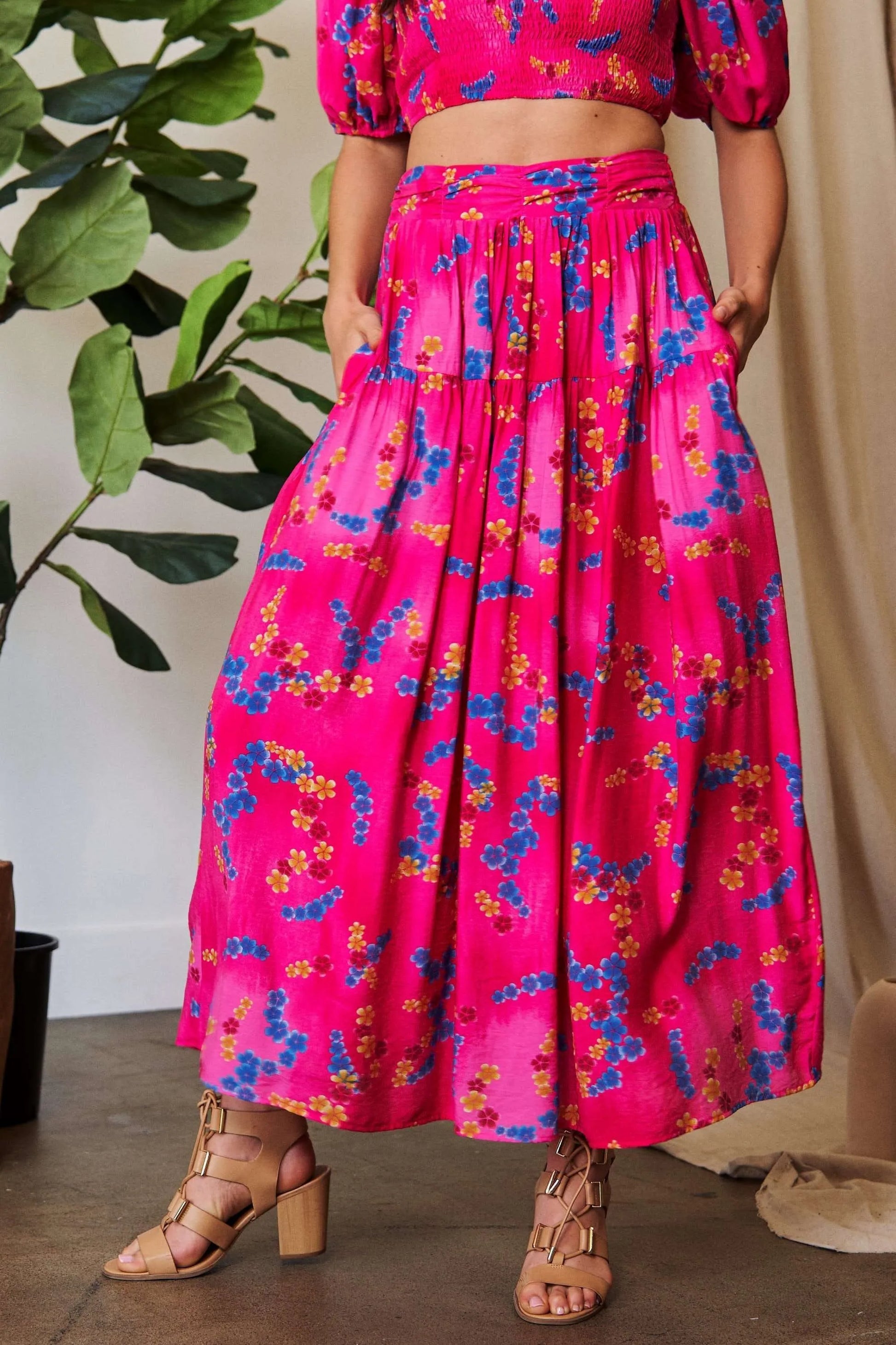 Candy pink Davi & Dani printed maxi skirt with smocking waistband and ruffled hem, stylish and flowy for a boho look.