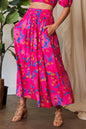 Candy pink Davi & Dani printed maxi skirt with smocking waistband and ruffled hem, perfect for stylish summer wear.