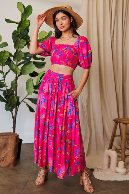 Candy pink Davi & Dani printed ruffled maxi skirt with smocking waistband, flowing and stylish for a boho-chic look.