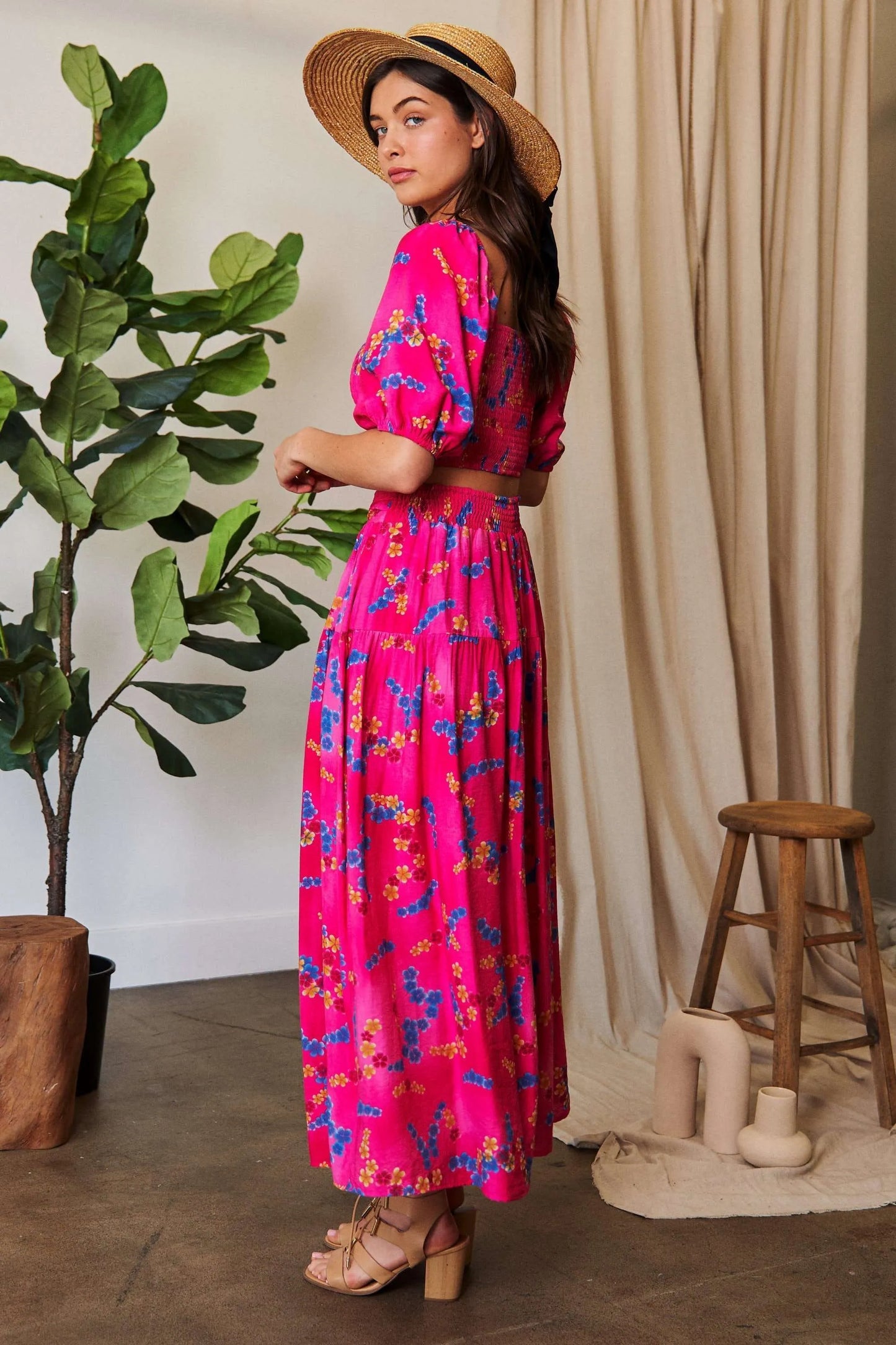 Candy pink Davi & Dani printed maxi skirt with smocking waistband and ruffled hem, perfect for a stylish, flowy look.