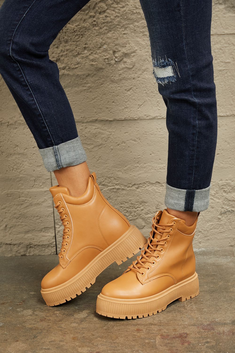 Caramel East Lion Corp platform combat boots with chunky soles and lace-up design, showcasing trendy footwear style.