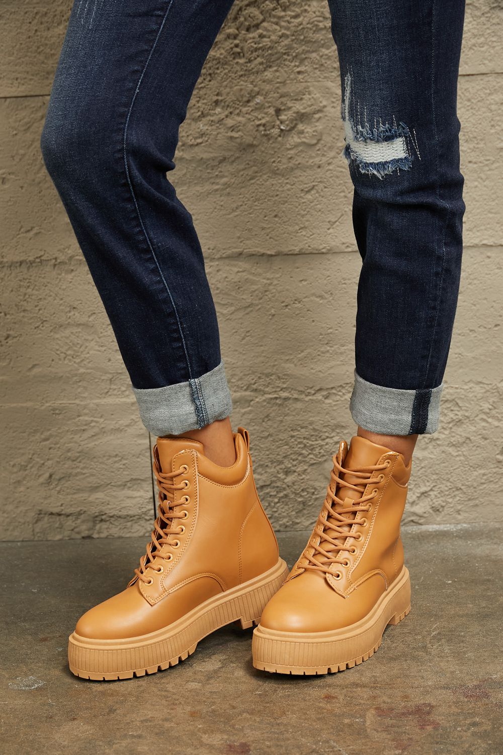 Caramel East Lion Corp platform combat boots with chunky soles and lace-up design, styled for a bold, edgy look.