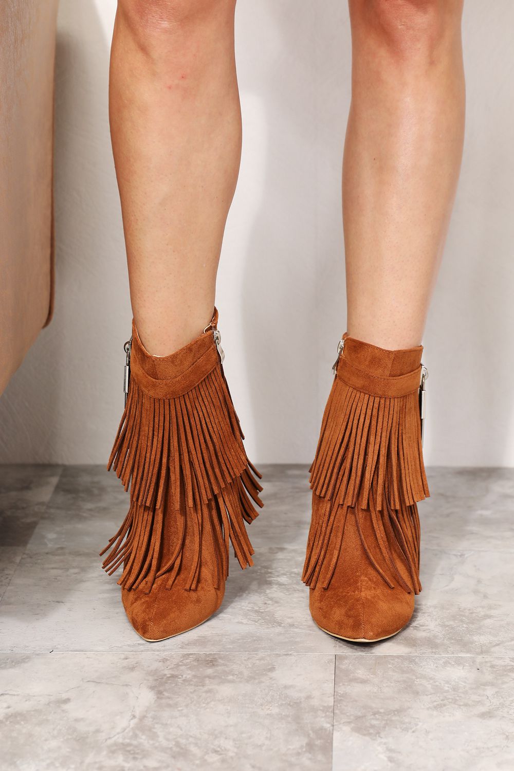 Caramel Legend women's tassel wedge heel ankle booties with stylish tassel details and a comfortable wedge heel.