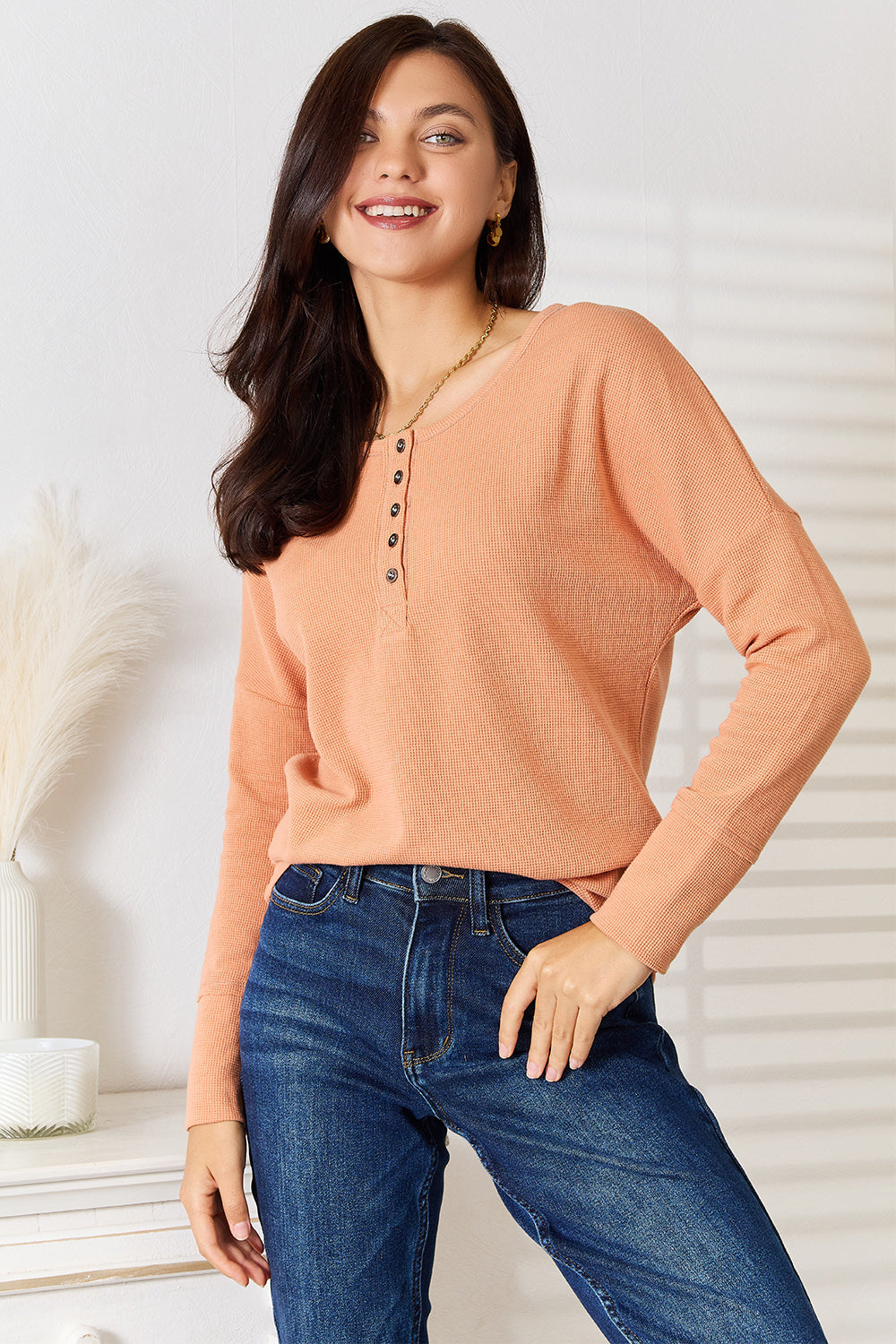 Caramel-colored Basic Bae half-button long sleeve top by Trendsi, showing its relaxed fit and stylish collar detail.