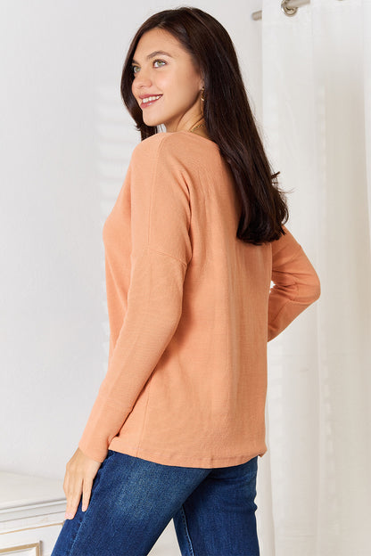 Caramel-colored Basic Bae half-button long sleeve top by Trendsi, featuring a relaxed fit and stylish half-button front.