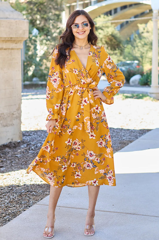 Caramel floral tie-back full-size dress with flounce sleeves, styled by Trendsi, featuring a flattering fit and vibrant pattern.
