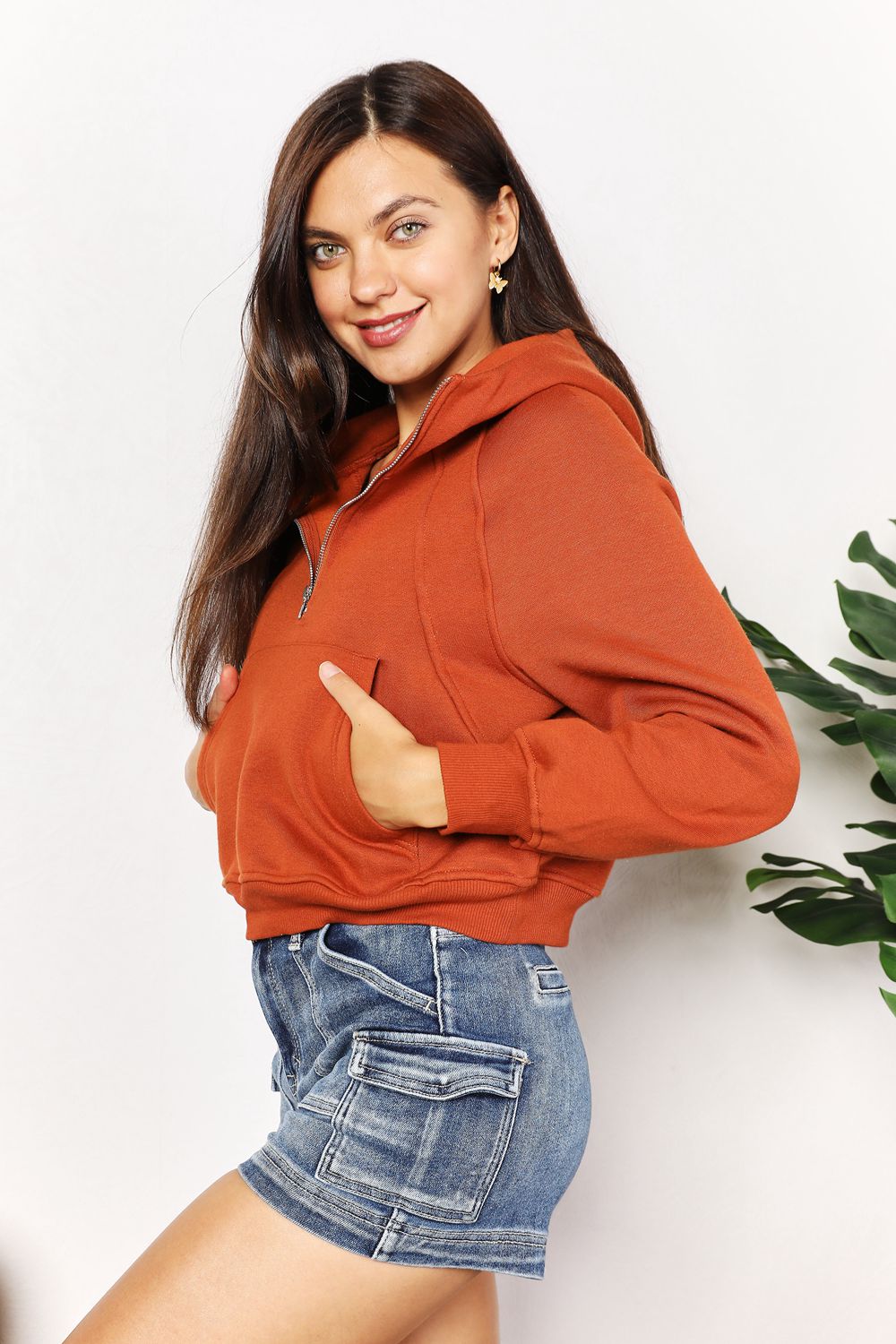 Caramel-colored Trendsi Double Take Half-Zip Long Sleeve Hoodie with a relaxed fit and front zipper, casual and comfortable.