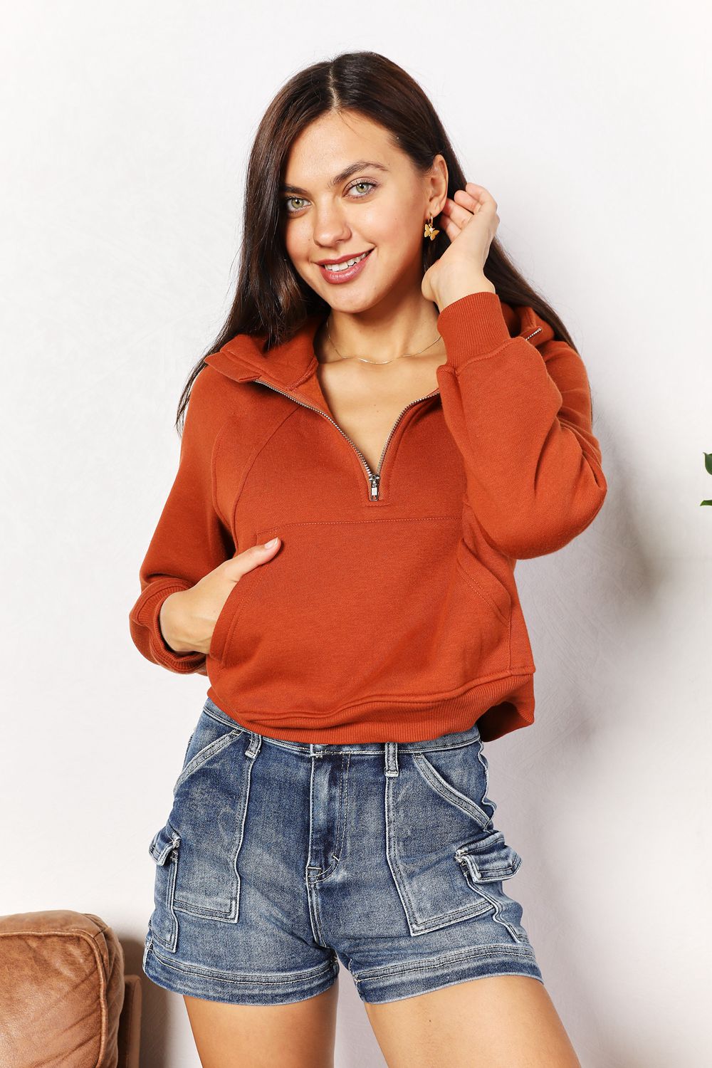 Caramel-colored Trendsi Double Take half-zip long sleeve hoodie with a relaxed fit and comfortable neckline.