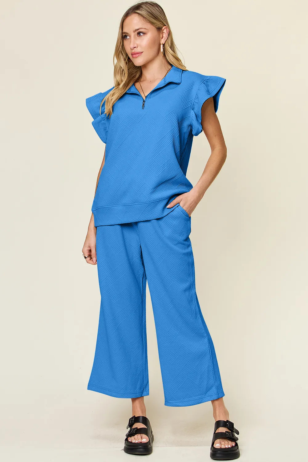 Cerulean blue Trendsi double take texture ruffle short sleeve top with matching drawstring wide-leg pants set on a model.