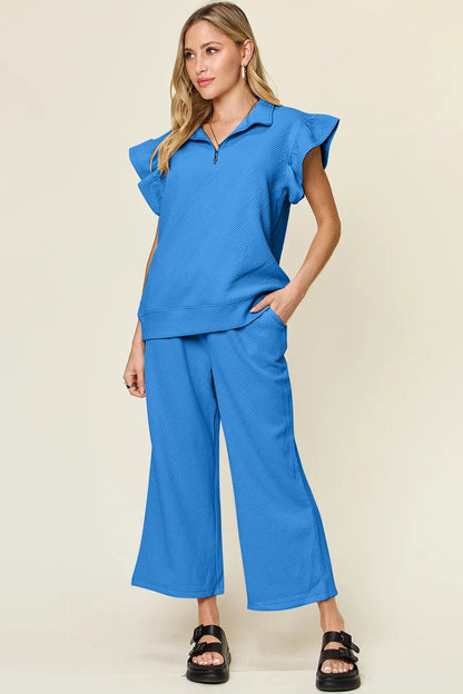 Cerulean blue Trendsi double take texture ruffle short sleeve top with matching drawstring wide-leg pants set on a model.