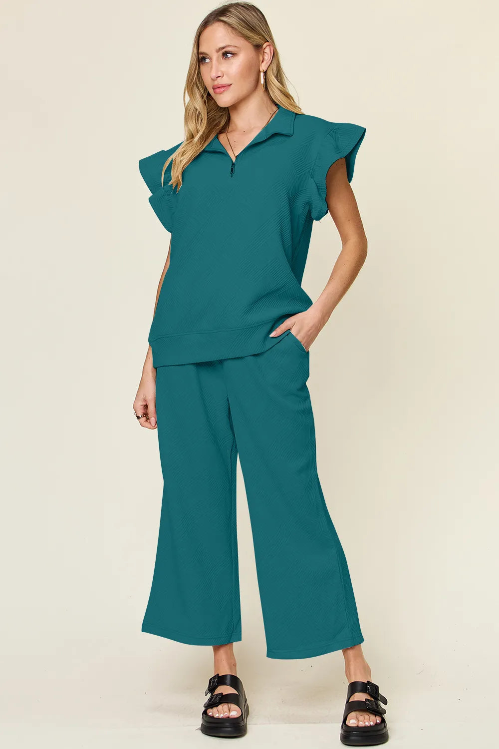 Cerulean double take textured ruffle short sleeve top with drawstring wide-leg pants set by Trendsi, styled for a casual look.