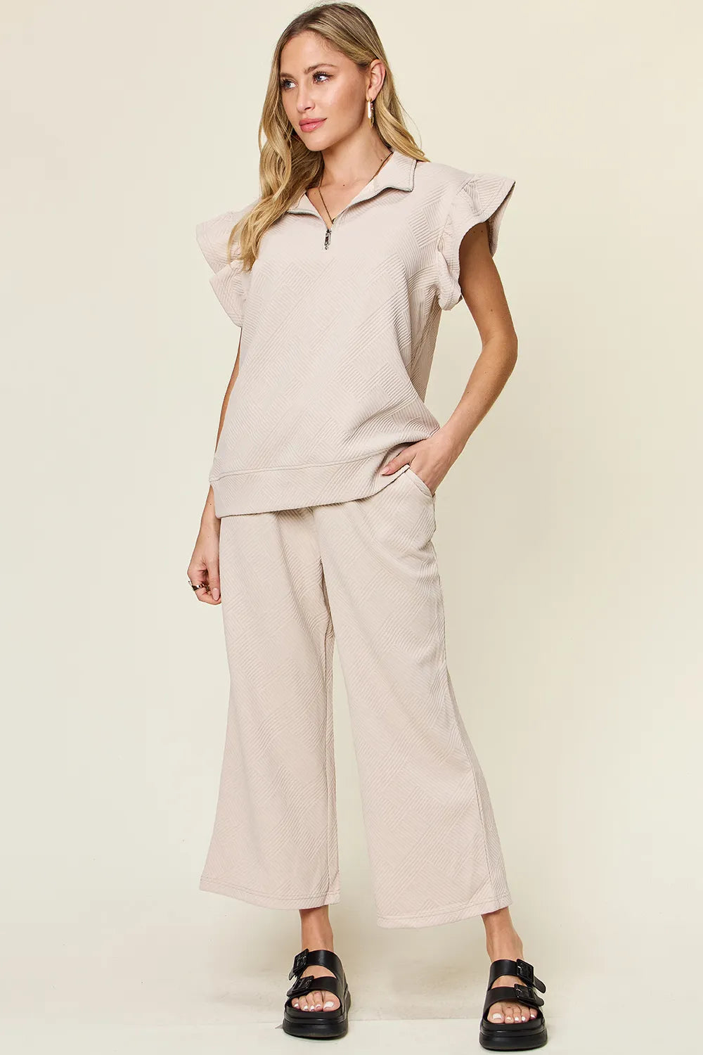 Cerulean blue double take texture ruffle short sleeve top with drawstring wide-leg pants set by Trendsi, displayed on a hanger.