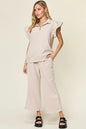 Cerulean blue double take texture ruffle short sleeve top with drawstring wide-leg pants set by Trendsi, displayed on a hanger.