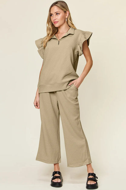 Trendsi cerulean double take texture ruffle short sleeve top with drawstring wide-leg pants set on a model.