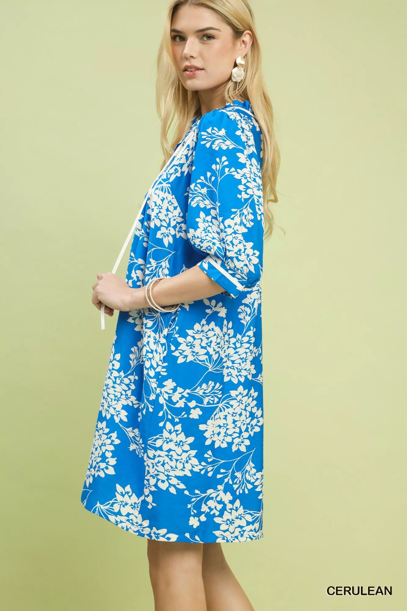 Cerulean Umgee floral babydoll dress with pockets, lightweight fabric, and feminine print, styled for casual or summer wear.