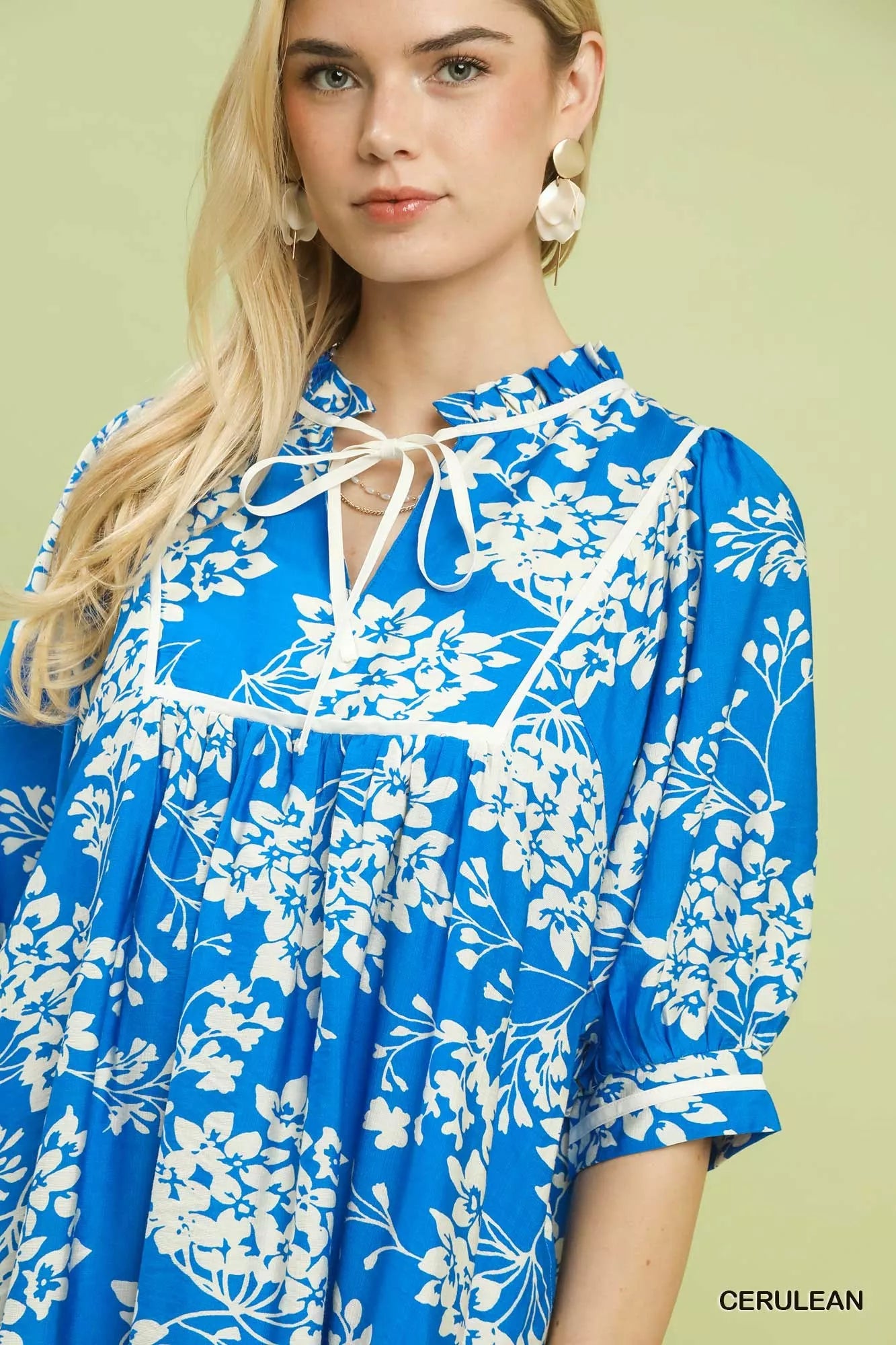 Cerulean blue Umgee floral babydoll dress with pockets, featuring a relaxed fit and feminine floral pattern.