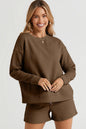 Trendsi double take chestnut textured long sleeve top and matching drawstring shorts set on a model.
