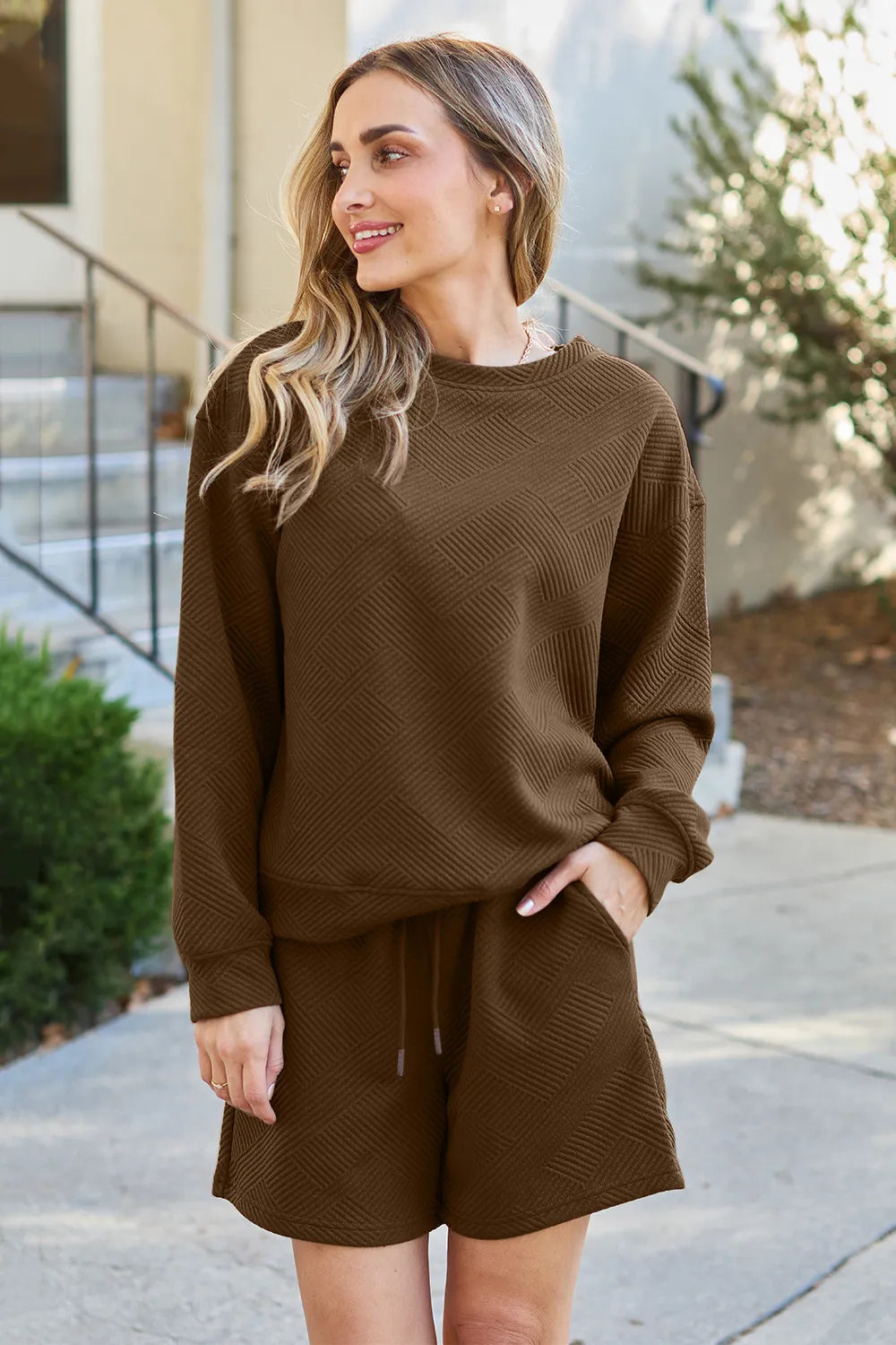 Trendsi Double Take chestnut textured long sleeve top and matching drawstring shorts set displayed on a model.