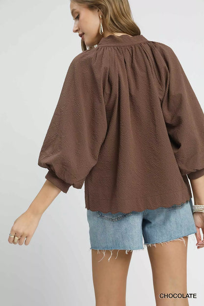 Plus size Umgee textured balloon sleeve blouse with notched details in chocolate color, featuring full-length sleeves and stylish design.