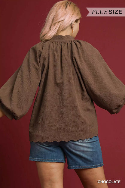 Chocolate brown plus size textured blouse with notched neckline and balloon sleeves, featuring a stylish, full-coverage fit.