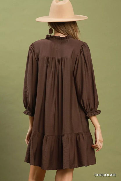 Chocolate brown Umgee mini dress with smocked bodice, ruffle details, and tiered skirt, perfect for casual or dressy occasions.