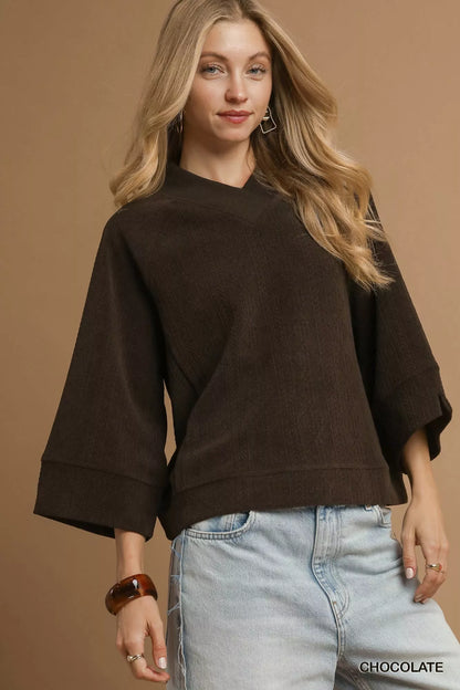 Chocolate brown textured knit V-neck top by Umgee featuring a relaxed fit and soft fabric, styled with casual accessories.