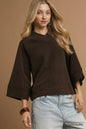 Chocolate brown textured knit V-neck top by Umgee featuring a relaxed fit and soft fabric, styled with casual accessories.