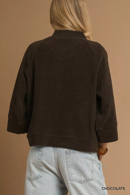 Chocolate brown Umgee textured knit V-neck top with long sleeves, styled for a casual look.