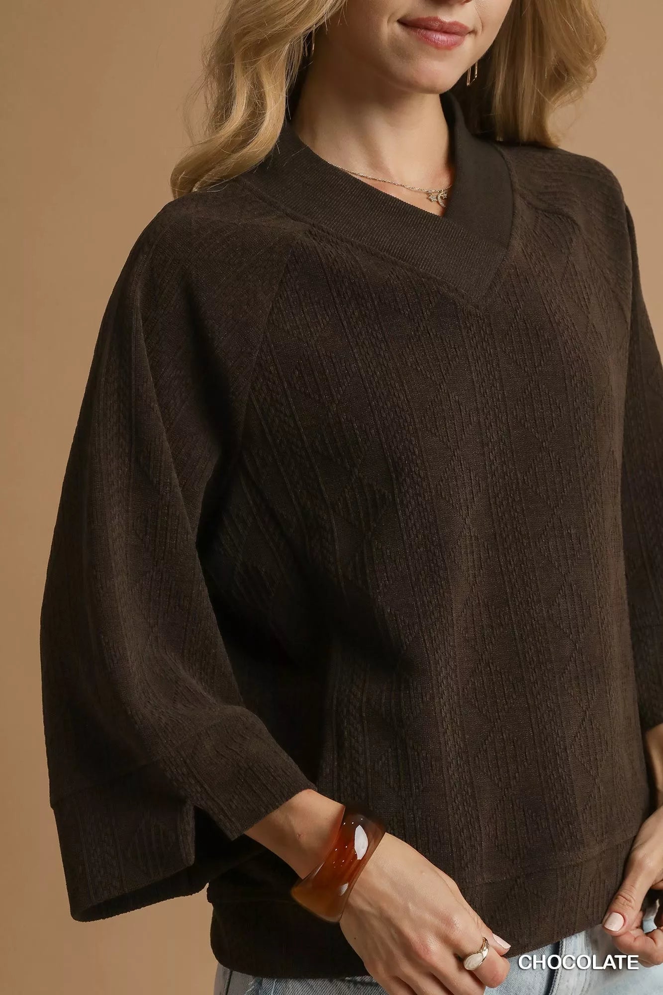 Chocolate brown Umgee textured knit V-neck top from Trendsi, featuring a cozy, stylish design with a ribbed knit pattern.