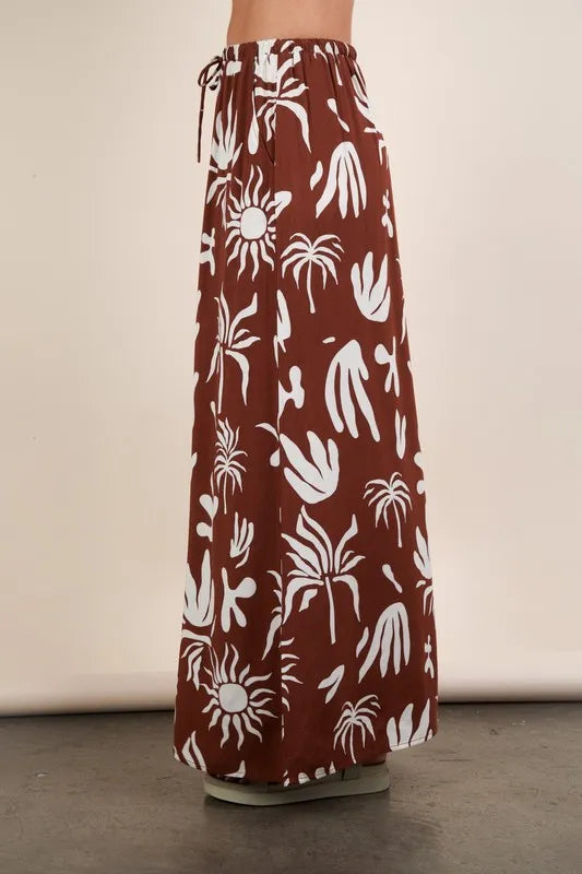 Chocolate brown Very J printed resort midi skirt from Trendsi, featuring a flowy fabric and stylish pattern, perfect for warm-weather wear.