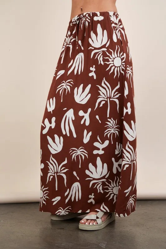 Chocolate brown printed resort midi skirt by Very J for Trendsi, featuring a flowy design and vibrant print pattern.