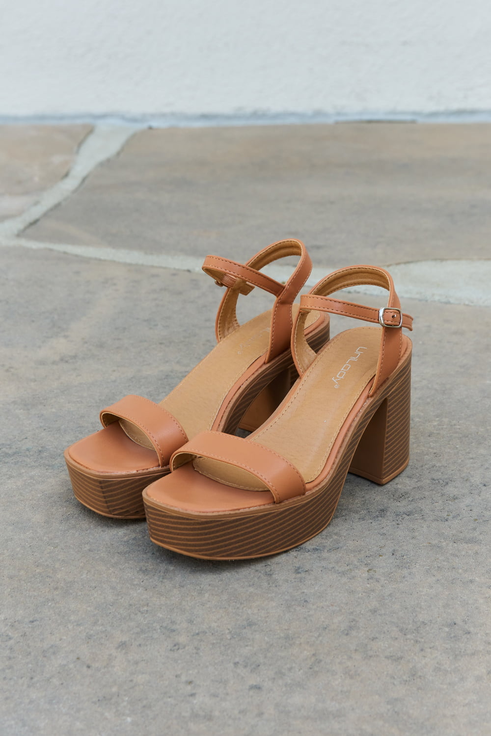 Cognac Weeboo Feel It platform heel sandals by Trendsi, featuring ankle straps and chunky heels, styled for summer wear.