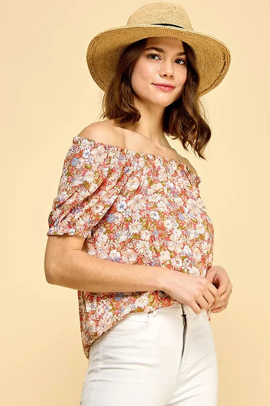 Lime 'N' Chili floral print short sleeve off-the-shoulder blouse by Trendsi, featuring vibrant colorful floral design and relaxed fit.