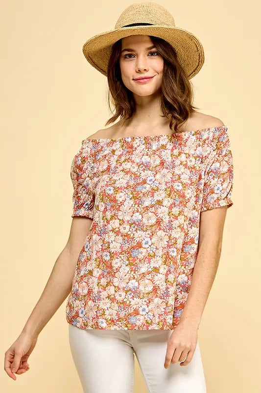 Lime 'N' Chili floral print short sleeve off-the-shoulder blouse by Trendsi, featuring vibrant colors and a relaxed fit.