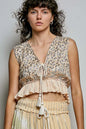 Trendi coral shimmer pattern sleeveless crop top with deep V neckline, tie front, tassel detail, and ruffle hem.