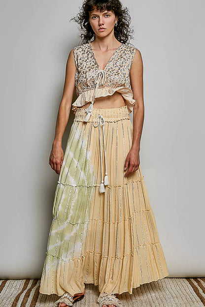 Trendsi coral haze multi-shimmer pattern sleeveless crop top with deep V neckline, tie front, tassels, and ruffle hem.
