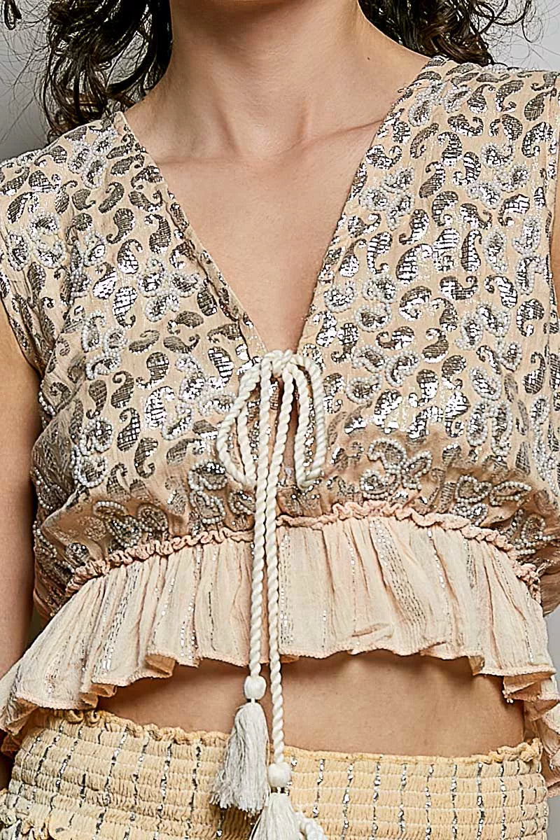 Coral Haze multi shimmer pattern sleeveless crop top with deep V neckline, tie front, tassels, and ruffle hem by Trendsi.