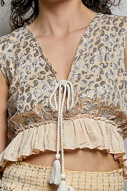 Coral Haze multi shimmer pattern sleeveless crop top with deep V neckline, tie front, tassels, and ruffle hem by Trendsi.