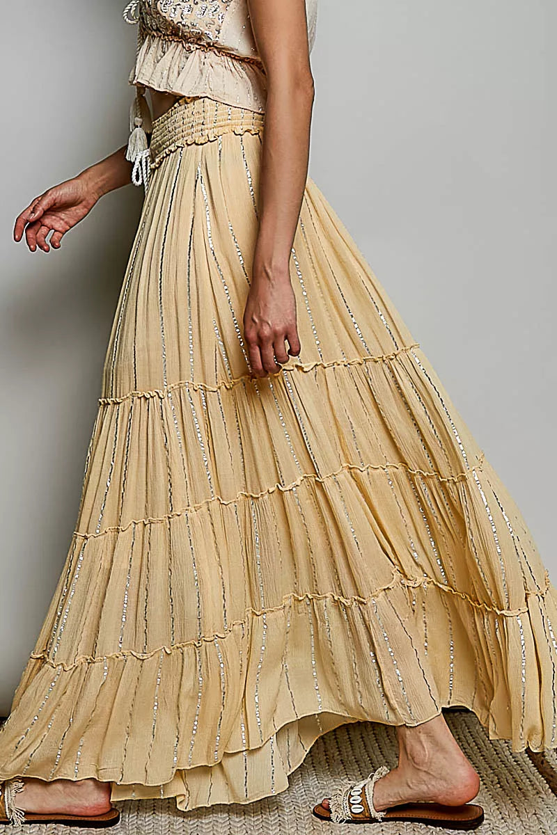Coral haze multi-tiered shimmer maxi skirt with reverse ruffles and smocked waist, designed by Trendsi.