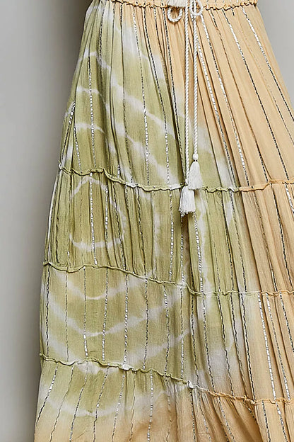 Coral Haze multi-colored shimmer tiered maxi skirt with reverse ruffles and smocked waist, designed by Trendsi.