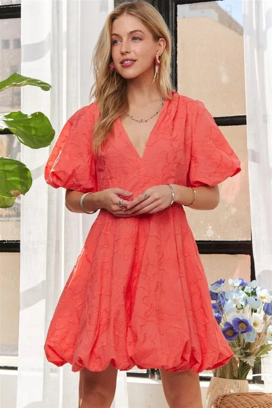 Coral ADORA floral dress with puff sleeves from Trendsi, featuring a flowy silhouette and vibrant floral pattern.